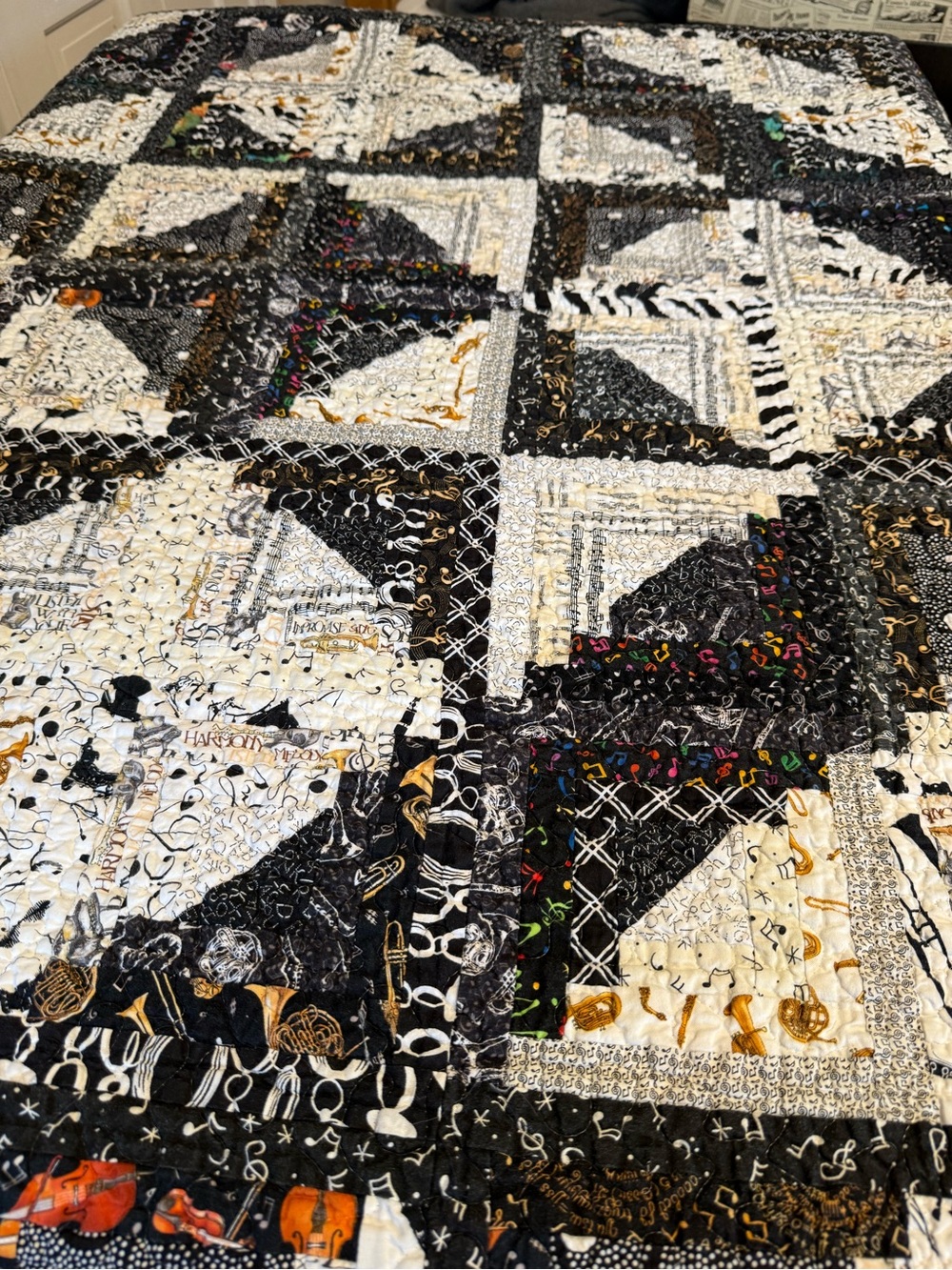 handmade quilt featuring a musical theme.